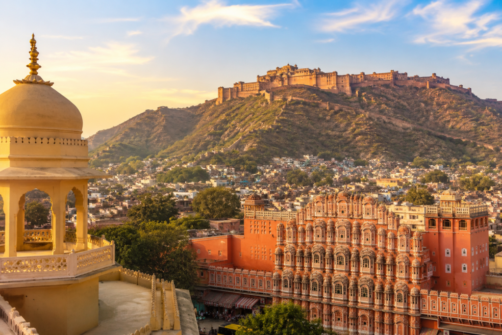 Jaipur Rajasthan – One of the Top Tourist Places in India Panoramic view of Jaipur featuring Hawa Mahal and Amber Fort showcasing Rajasthan’s heritage architecture